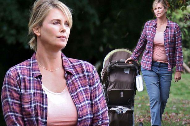 A heavier looking Charlize Theron is spotted on the set of 'Tully' in Vancouver, Canada. The film is about Marlo, a mother of three including a newborn, who is gifted a night nanny by her brother.